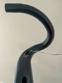 A bent steel wire catching a Di2 wire plug out of the opening lug of a handlebar