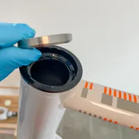 A hand inserting the bearing into the top cup