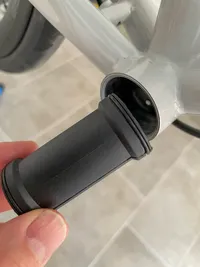 A hand holding the Rotor BB1 plastic cover aside of the bottom bracket shell