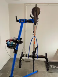 The bike in the repair stand with the front wheel pointing down and the back wheel pointing up