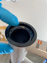A hand applying grease to the headset top cup