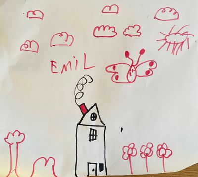 A house drawn with black felt tip pen. The chimney is drawn with a red felt tip pin and so are the clouds, the sun, the flowers, and a big butterfly.