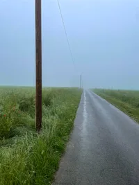 A wet but paved dirt track.