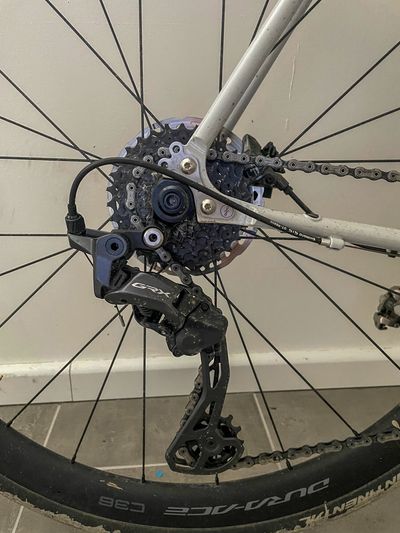 Close image of a GRX 820 mechanical rear derailleur mounted to a white Fairlight Strael with C36 Dura-Ace wheels.