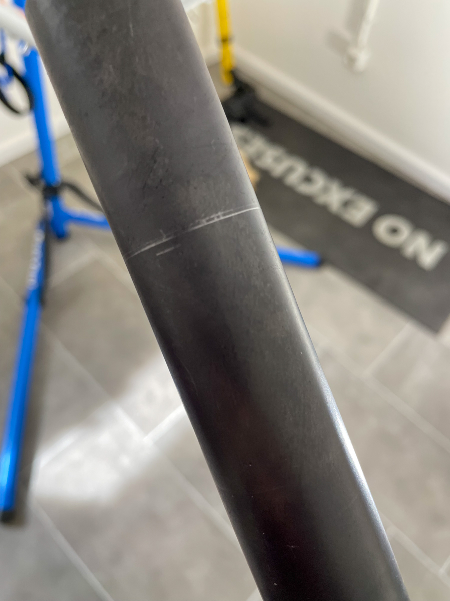 A steerer tube with three pencil lines to identify the final cut line