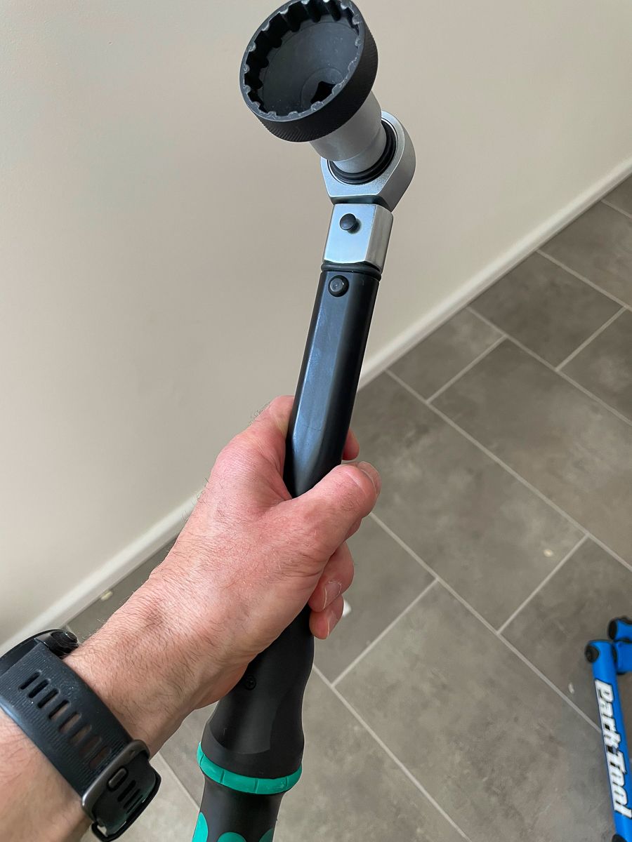A hand holding a huge torque wrench