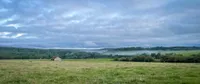 A misty green valley with woods and meadows